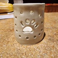 Single white candle holder votive with a paw print carved into it, perfect for lighting in honour of your pet(s)